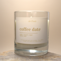 Candle in a glass jar labeled 'coffee date' on a neutral background