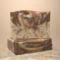 Two soap bars with a marbled pattern on a beige background