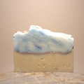 Bar of soap with blue and white swirls on a beige background, branded 'drifted'.