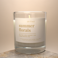 Candle with 'drifted summer florals' label on a neutral background